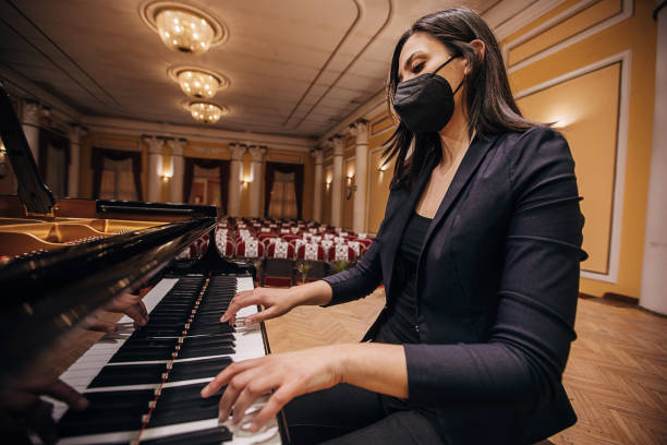 istock Female playing piano at concert hall 1307944398