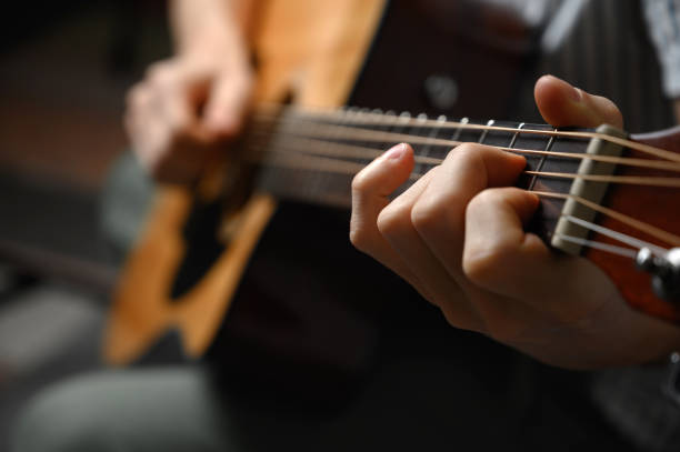 istock Man playing acoustic guitar, cover for online courses, learning at home. 1307944713
