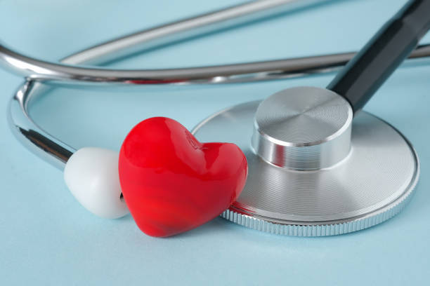 istock Stethoscope and heart on blue background 1307945700