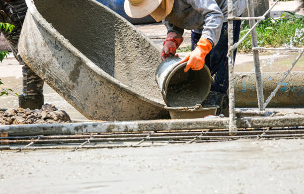 istock worker team building house use bucketmix and fill liquid cement on floor. Making concrete street in construction site 1307945890