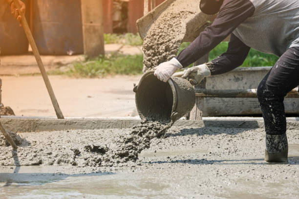 istock masonry labor building house use bucket mix and fill liquid cement on floor. Making concrete street in construction site 1307945892