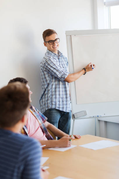 istock group of smiling students with white board 1307946660