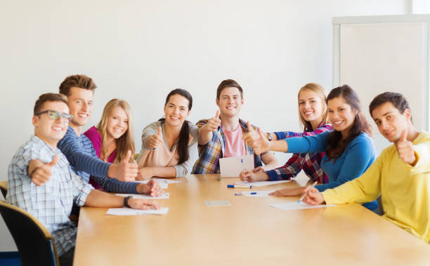 istock group of smiling students with hand on top 1307946957