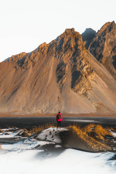 istock Man backpacker tourist exploring the scenic wilderness landscape in Iceland during bright sunrise outdoors 1307947950