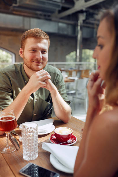 istock Couple sit in coffeeshop have fun and  enjoyed on talking 1307949163