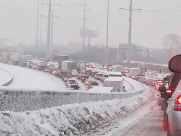 Horizontal view from a drivers perspective being stuck on the on-ramp to an interstate highway during a raging midwestern winter blizzard