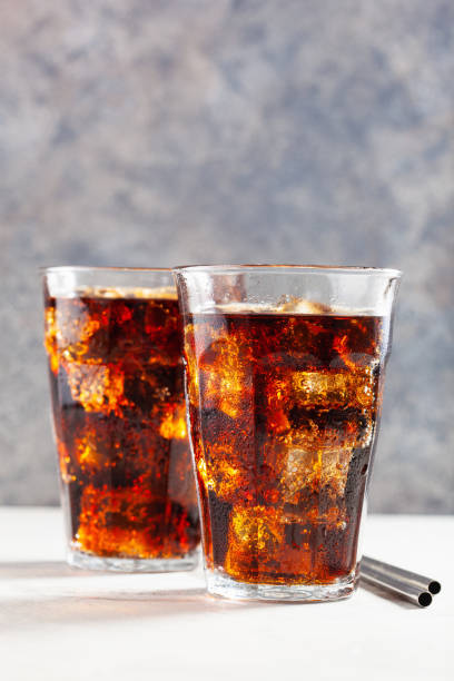 istock glass of cold cola soft drink with ice on concrete background 1307950894