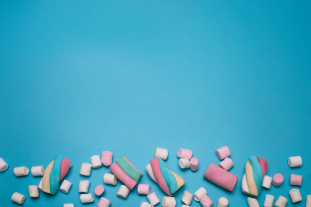 istock Marshmallows on the blue background, with free space for text. 1307951803