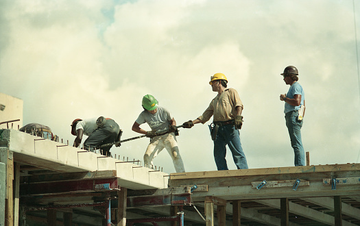 June 13, 2013. The summer sun beats down on a crew of construction workers seen handling rebar on top of a building under construction near Aventura, Florida.  Limited available land and a growing population has led to a 10% annual appreciation of South Florida real estate since 2010.