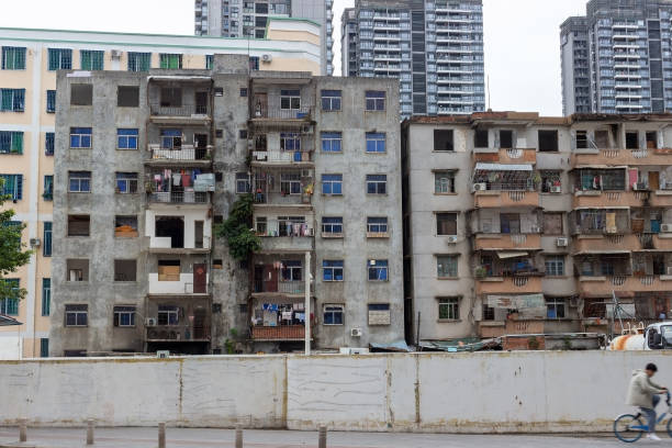 Remains of the last quarters on Hainan island, China China, Hainan island, Sanya - January 26, 2020: Remains of the last quarters with old residential buildings of workers, which will soon be destroyed and built up with skyscrapers in Sanya city, Hainan island, China. chinese slum stock pictures, royalty-free photos & images