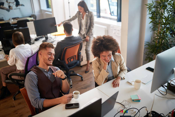 istock two colleagues smiling while working in modern office. casual modern business 1307956974