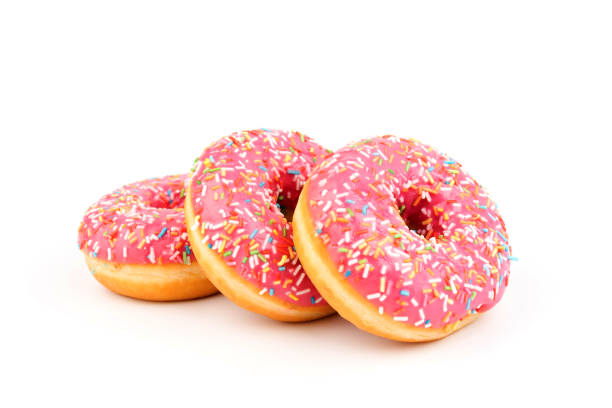 istock Fresh made Donuts isolated on white background. Doughnuts are traditional sweet pastries. Copy space for text. 1307957388
