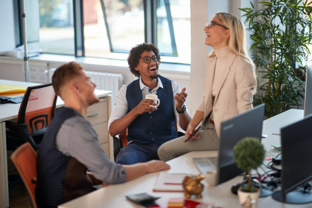istock three colleagues having fun at work in office. casual, modern, business 1307957447