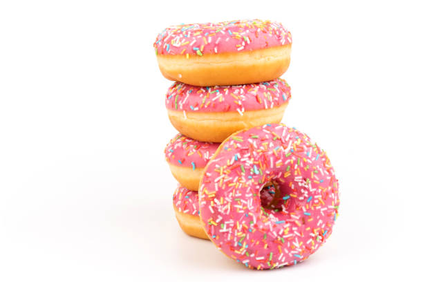 istock Fresh made Donuts isolated on white background. Doughnuts are traditional sweet pastries. Copy space for text. 1307957495