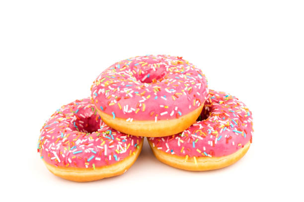 istock Fresh made Donuts isolated on white background. Doughnuts are traditional sweet pastries. Copy space for text. 1307957565