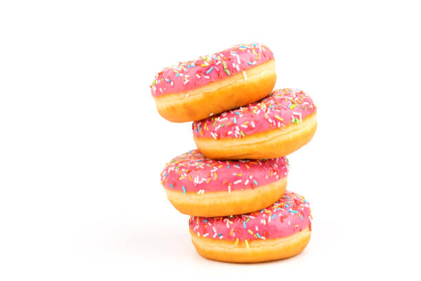 istock Fresh made Donuts isolated on white background. Doughnuts are traditional sweet pastries. Copy space for text. 1307957569
