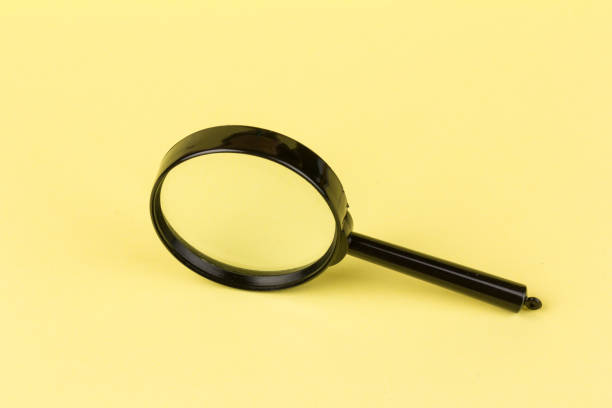 istock magnifying glass  loupe search symbol on yellow background with copy space 1307957866
