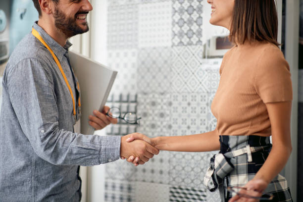 Salesman handshake customer .Successful shopping. stock photo