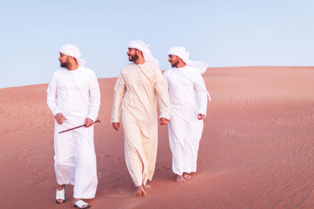 istock Arabs walking and exploring the dunes of Arabia 1307960645