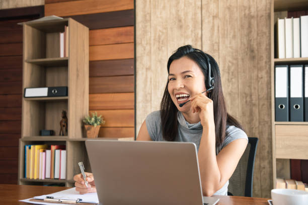 istock Call centre employees are smiling and working on laptop computer 1307961348