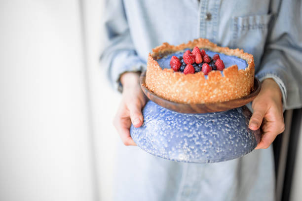 istock Woman holding berry cheesecake 1307961621