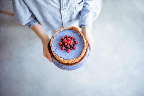 istock Woman with berry cheesecake 1307961643
