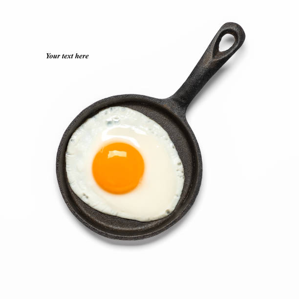 istock Fried egg in a frying pan isolated on a white background. Top view, flat lay. 1307961791