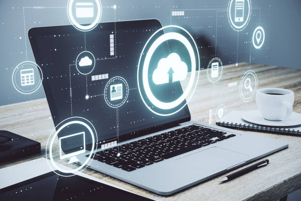 istock Cloud service technology concept with digital data storage icons and opened laptop with coffee cup on background 1307962603