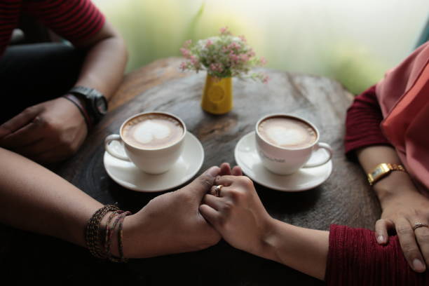 istock Midsection of woman holding coffee cup 1307962670