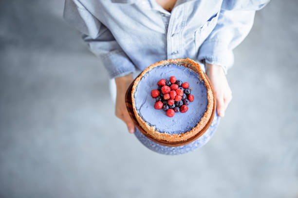istock Woman with berry cheesecake 1307962684