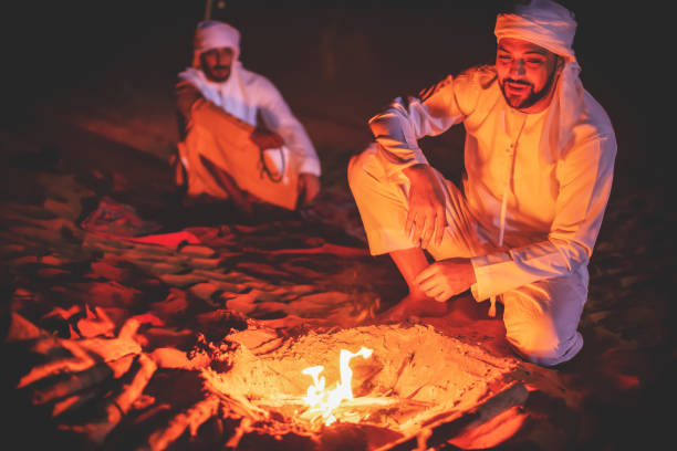 istock Arabs starting the campfire in the desert 1307962766