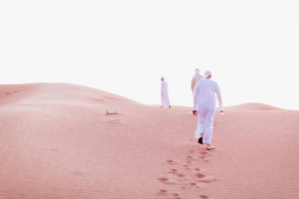 istock Arabs walking and exploring the dunes of Arabia 1307962776