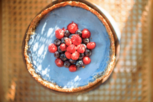 Berry nut cheesecake on a wooden chair with a sunshine, Close-up view from above