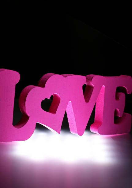 istock pink love word on black background 1307964067