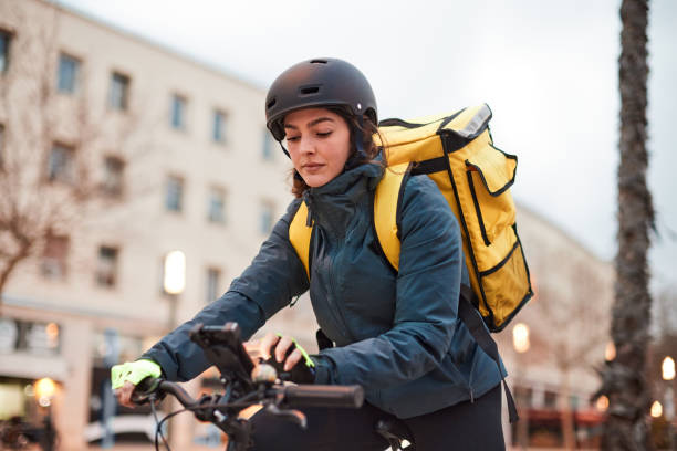 istock A delivery biker stops to check the GPS app on the phone. 1307965038