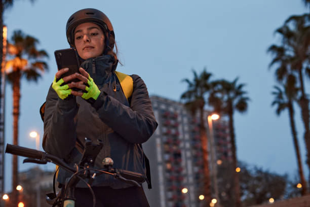 istock A Delivery biker looking at orders on her phone. 1307965039