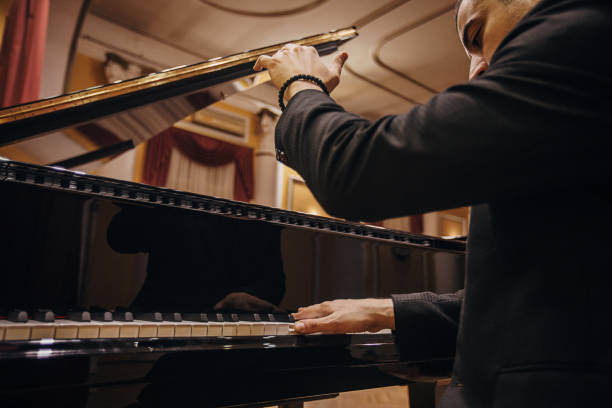 istock Male playing piano at concert hall 1307965068