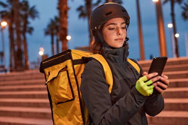 istock A female Delivery biker with a phone. 1307965070