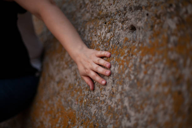 istock Woman hand lies on stone surface 1307967417