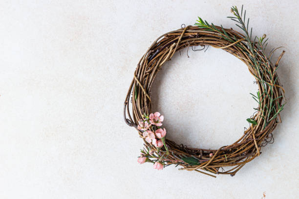 istock Decorative spring wreath made of twigs and flowers. DIY creativity. 1307967795