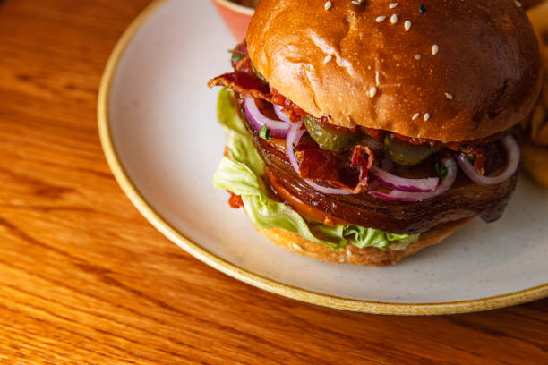 istock Burger sandwich with salmon, cream cheese, avocado and arugula on a light background, concept diet food 1307967812