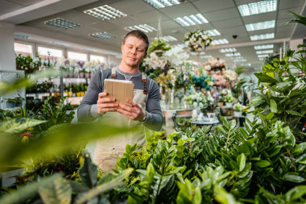 istock The florist using tablet in flower shop 1307969055