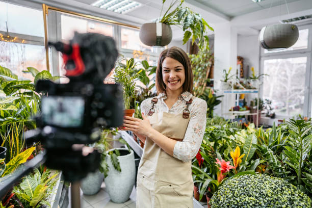 istock Female florist worker vlog recording 1307970280
