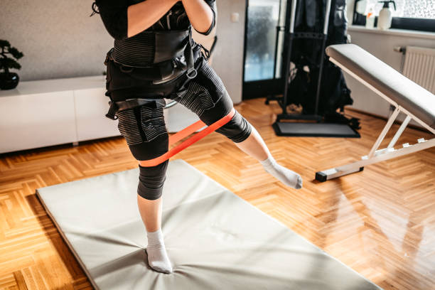 istock Woman wearing EMS suit on training 1307972058