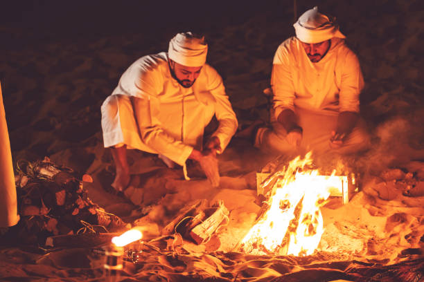 istock Arab friends at a desert camp grilling fresh kebab 1307974434