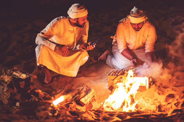 istock Arab brothers grilling fresh meat at a desert camp 1307974435