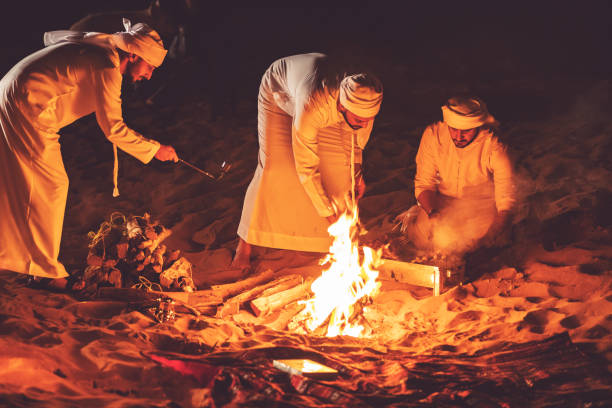 istock Arab friends at a desert camp grilling fresh kebab 1307975064