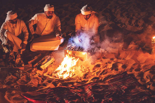 istock Arab friends at a desert camp grilling fresh kebab 1307975069