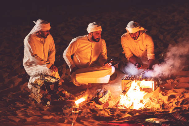 istock Arab friends at a desert camp grilling fresh kebab 1307975275