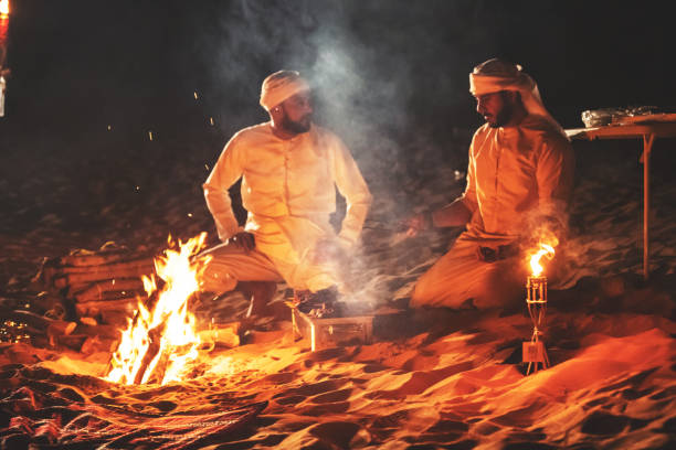 istock Arab friends at a desert camp making fresh kebab on a grill 1307975420